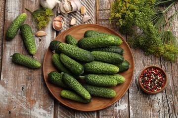 Making pickles. Fresh cucumbers and spices on wooden table, flat lay