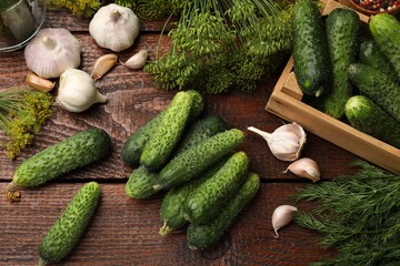 Making pickles. Fresh cucumbers and spices on wooden table, flat lay