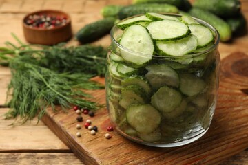 Making pickles. Fresh cucumbers and other ingredients on wooden table, closeup