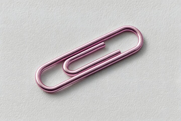 Pink Metallic Paperclip on Gray Textured Background