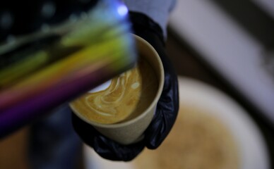 Bartender decorates cappuccino coffee