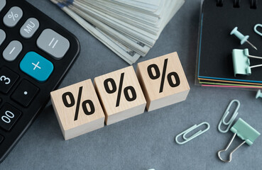 A calculator, a stack of bills, and a stack of paper clips