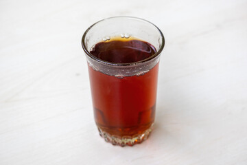 A refreshing glass of hot black tea, a timeless and healthy beverage. This invigorating red tea drink provides natural warmth, ideal for a relaxing break.