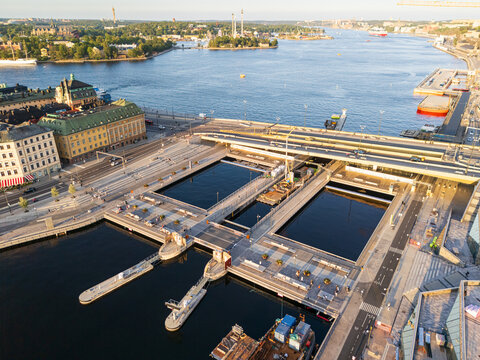 Aerial view of the vibrant waterfront and bridges of Vattentorget near Slussen, where the dark waters meet the light stone buildings, Stockholm, Sweden.