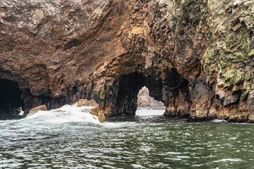 A dramatic view of the rugged coastal cliffs of the Ballestas Islands in Peru