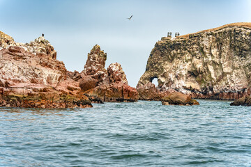 A dramatic view of the rugged coastal cliffs of the Ballestas Islands in Peru