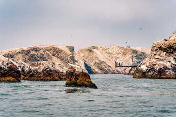 A dramatic view of the rugged coastal cliffs of the Ballestas Islands in Peru