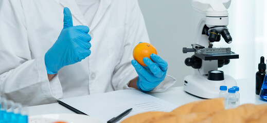 Scientist guaranteer no chemical on fruit residues in laboratory. Control experts inspect the...