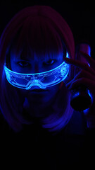 woman in neon pink light wearing cyber glasses. pink hair