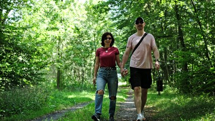 Young Couple Enjoys A Stroll In The Forest