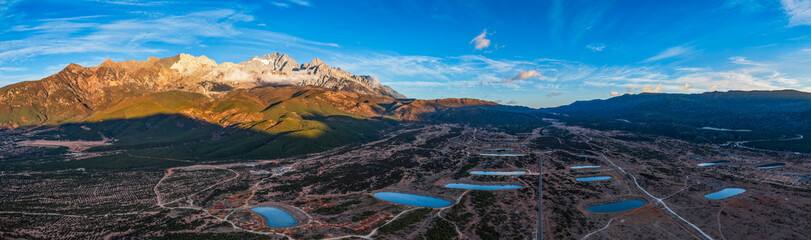 The view of Yulong Snow Mountain bathed in sunlight on the golden Mountain