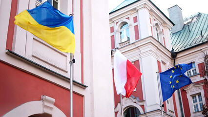 Waving Flags Of Ukraine, Poland, And Eu Symbolize United Europe