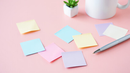 Pastel Workspace Flat Lay with Sticky Notes, Pen, and Succulent Plant on Pink Background for Creative Planning and Organization in a Modern Office Setting