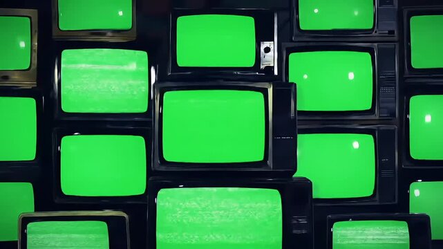 Wall of old cathode-ray tube televisions with green screens, retro technology setup