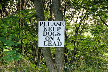 Old Hand Made Please Keep Dogs On A Lead Sign at a Countryside Location