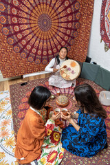 Women sharing organic cocoa during ceremony with tambourine music