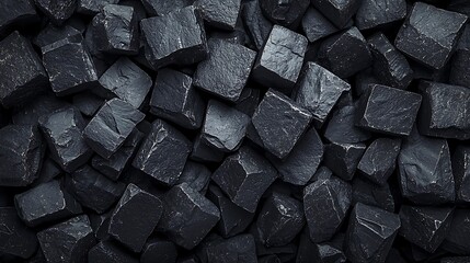 Close-up image of black charcoal briquettes stacked tightly together, showing textured surfaces and a matte finish.