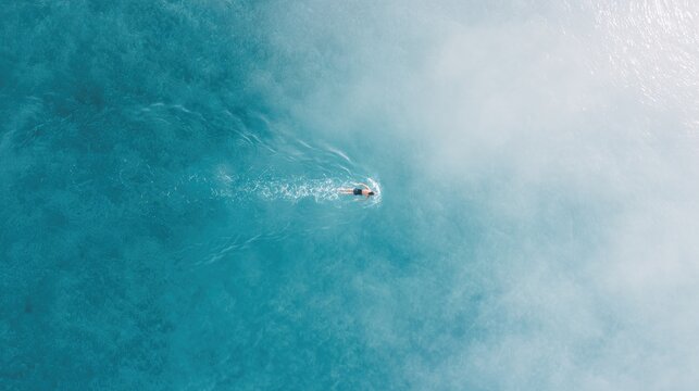 lone swimmer glides through pristine waters at sunrise embodying grace and determination