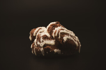Profiteroles with coconut cream on a black background.