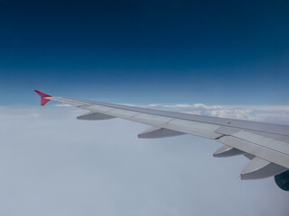 Airplane flying low over snowy mountains and preparing for landing to the airport. Beautiful view...