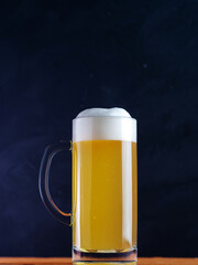 small mug of foamy beer on the table