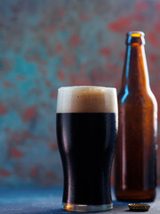 Cold dark beer glass from bottle. Copy space. Craft beer stout