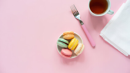 Overhead Flat Lay of Macarons, Tea, Fork, and Napkin on Pink Background for Food Photography, Dessert Concepts, and Sweet Treat Themes with Delicate and Pastel Aesthetic