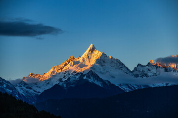 Aerial view of the Golden Mountain bathed in sunlight on Meili Snow Mountain in Yunnan Province