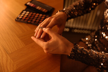 Beautiful woman getting ready at dressing table indoors, closeup