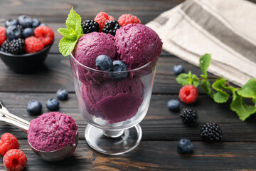 Delicious sorbet with fresh berries and mint on wooden table, closeup