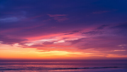 Obraz premium stunning gradient colors fill sky at sunset transitioning from deep purple to vibrant pink and warm yellow creating serene and calming atmosphere that evokes tranquility