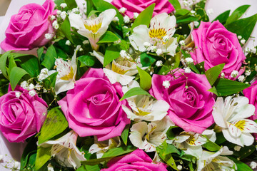 Beautiful bouquet of pink roses and white alstroemeria. Bunch of many colorful fragrant flowers. Floristry and floral design concept. Floral texture