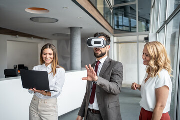 Business team using virtual reality headset and laptop in modern office