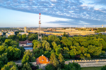 Great Strahov Stadium stands prominently in Prague, surrounded by lush trees and a tranquil setting. The scene captures the beauty of this historic site during a clear day.