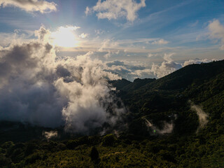 Beautiful aerial view of wind Mills - turbines- on Costa Rica’s hills at sunset, overlooking San José city with vibrant skies, renewable energy, and a stunning mountain landscape