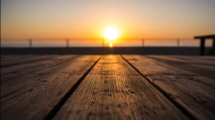 Fototapeta premium A wooden deck extends toward a blurred sunset, parallel planks with visible grain texture under warm golden light,