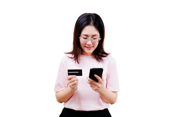 Fototapeta premium Asian young beautiful woman wearing glasses is holding a credit card in one hand and a smartphone in the other, looking at the phone with a slight smile.