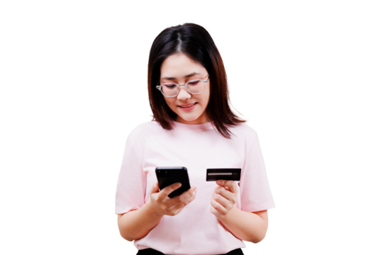 Asian young beautiful woman wearing glasses holds a smartphone in one hand and a credit card in the other, appearing to complete an online transaction or mobile payment.