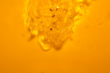 Bubbles and Swirls in Bright Yellow Liquid Background