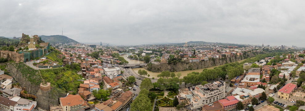 Aerial view of the Kura River meandering through the city, shadowed by the ancient Narikala Fortress, Tbilisi, Tbilisi, Georgia.