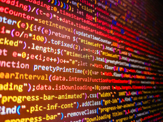 Website codes on computer monitor. Real Java Script code developing screen. Python programming developer code. Binary code digital technology background. HTML markup language closeup