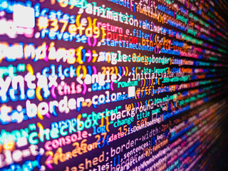 Web site codes on computer monitor. Coworkers team in modern office. Programming code abstract technology. Screen of web developing code on dark background. Technology background. Programmer workplace