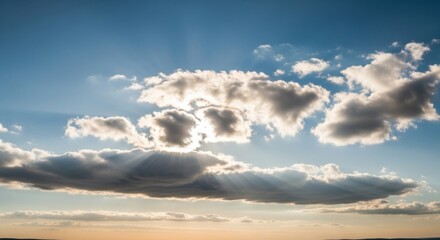 Sunlight Beaming Through Wispy Clouds Against a Blue Sky at Sunset