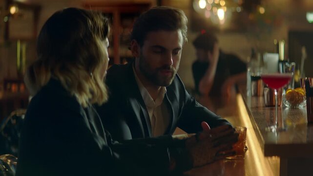 Beautiful Caucasian couple having a date in a stylish restaurant, talking and laughing. Shot with 2x anamorphic lens