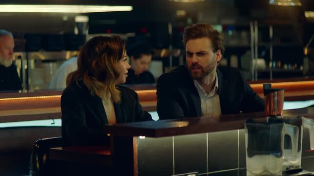 Beautiful Caucasian couple having a date in a stylish restaurant, talking and laughing. Shot with 2x anamorphic lens