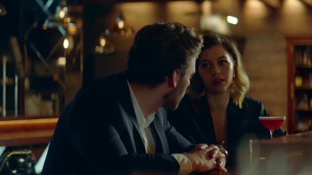 Beautiful Caucasian couple having a date in a stylish restaurant, talking and laughing. Shot with 2x anamorphic lens