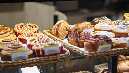 a wide range of freshly baked French pastries on display in a bakery in the morning. fresh pastries concept
