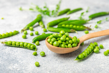 Fresh green pea pods with green peas on a wooden background. Sweet green peas. Green pea beans vegetables. Vegan. healthy vegetable. Copy space