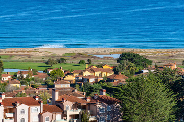 The tranquil beauty of Quintay's coastline in Chile, with residential buildings blending into the natural beach and ocean landscape.