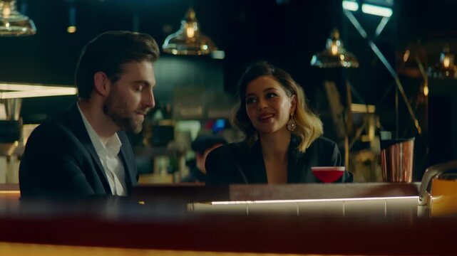Beautiful Caucasian couple having a date in a stylish restaurant, talking and laughing. Shot with 2x anamorphic lens